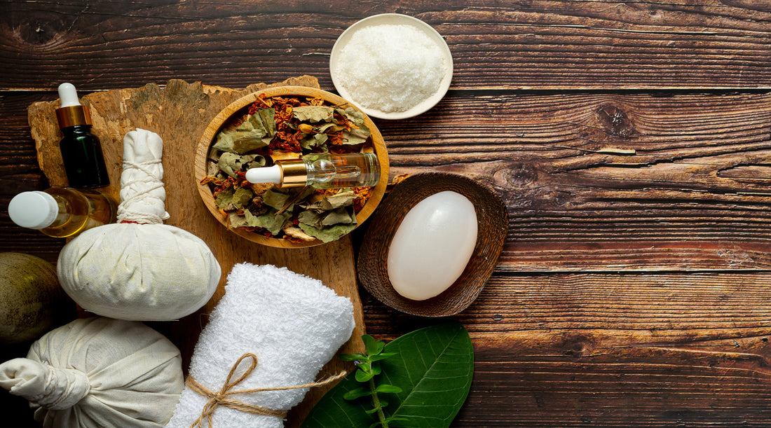 there are bowls with Ayurvedic medicine and herbs on a wooden floor